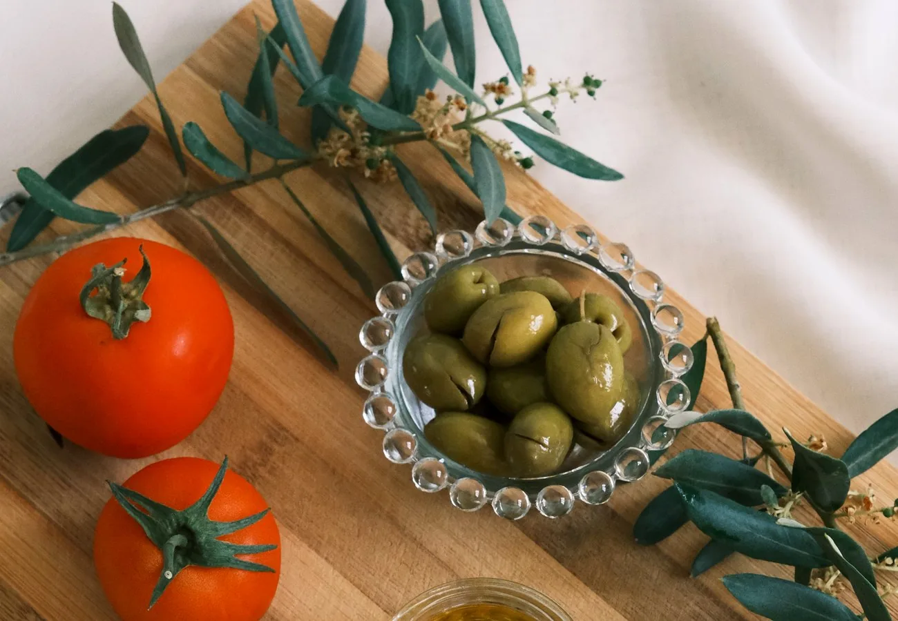 Olives and olive oil on a wooden board